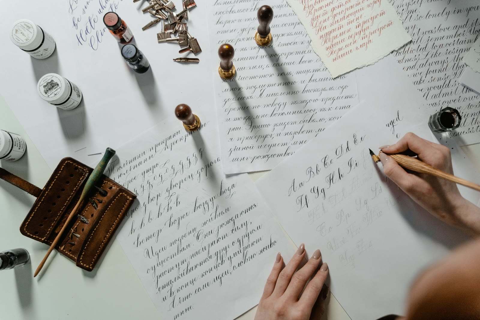 Calligraphy practice with ink bottles and handwritten notes