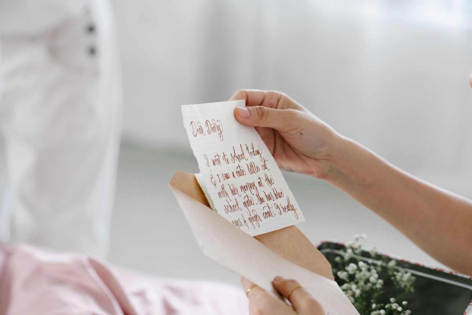 Reading a handwritten "Dear Diary" note pulled from an envelope